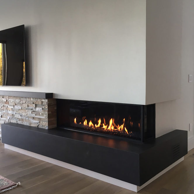 Two sided modern gas fireplace with safety screens.