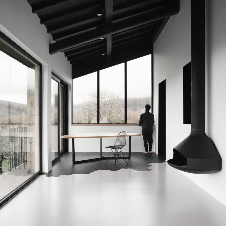 Paxfocus suspended fireplace in a monochromatic modern home
